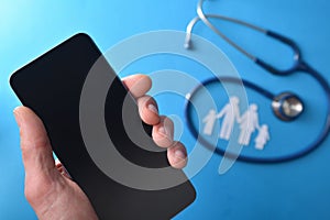 Family healthcare phone care concept with hand holding a smartphone
