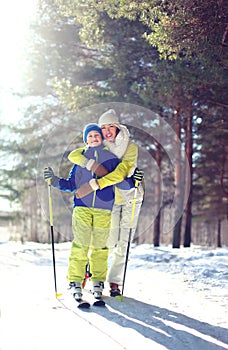 Family healthy lifestyle! Mother and son go skiing in the woods