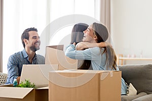 Family with heap of carton boxes in living room