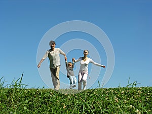 Family on herb under blue sky