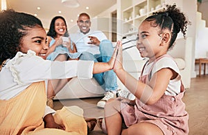 Family, high five and children playing, smile and having fun in a living room. Kids, hands and games with parents