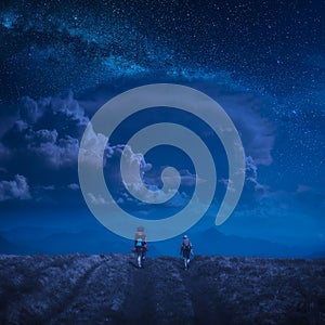 Family hikers under the starry sky