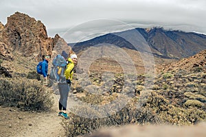 Family hiking with baby boy travelling in backpack