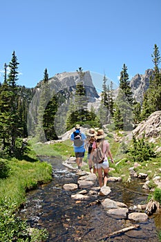 Family hiking in mountains on summer vacation.