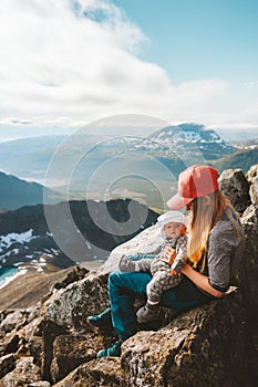 Family hiking in Norway mother and baby traveling in mountains healthy lifestyle mom with infant child together