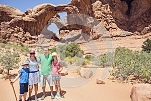Family hiking and sightseeing together at Arches National Park