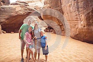 Family hiking and sightseeing together at Arches National Park