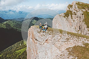 Family hiking sitting on mountain cliff travel with baby adventure vacations outdoor