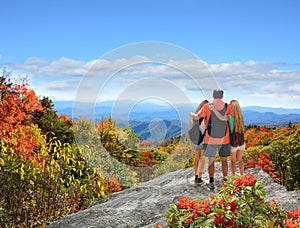 Family hiking on vacation in autumn mountains.