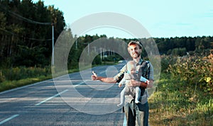 Family hitchhiking. Father with his little son wait for car.