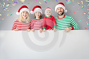 Family holding cardboard banner blank