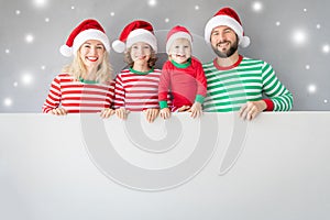 Family holding cardboard banner blank