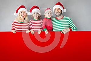 Family holding cardboard banner blank