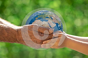 Family holding Earth planet in hands