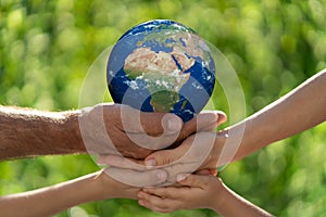 Family holding Earth planet in hands