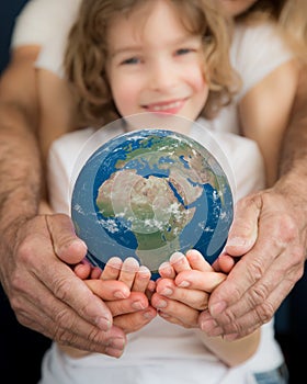 Family holding Earth planet in hands