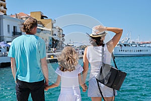 Family holding hands, back view, sea mediterranean vacation