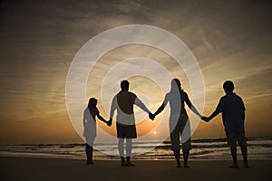 Family Holding Hands on Beach