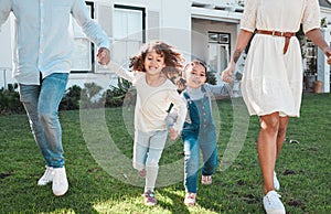 Family, holding hands and kids running with their parents outdoor in the garden of their home together. Children, fun