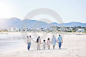 Family, holding hands and walk at beach with mockup space by water, together or bond with love in summer holiday. Men