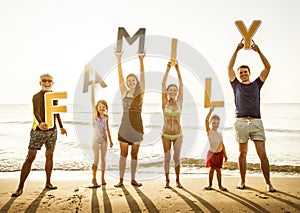 Family holding up letters at the beach