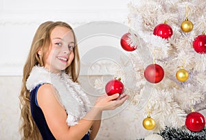 Family holiday concept. Girl velvet dress feel festive near christmas tree. Spread christmas cheer. Kid happy because