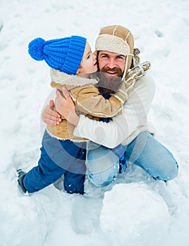 Family holiday and togetherness. Daddy and boy smiling and hugging. Best winter game for happy family. Concept of