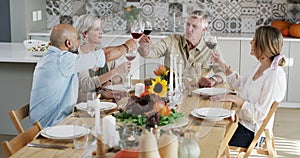 Family, home and champagne toast for holiday celebration, thanksgiving and lunch or brunch at dining room table. Senior