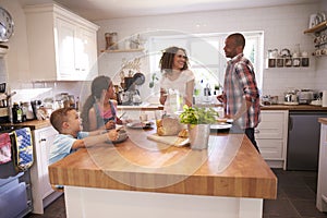 Family At Home Eating Breakfast In Kitchen Together