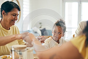 Family home, lunch and holding hands for praying together, religion or faith with comic girl child at table. Grandmother