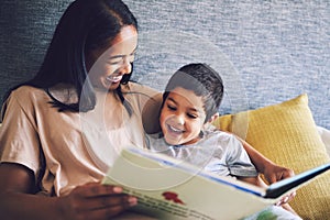 Family home, mother and child reading a book in a bed together with love, care and security or comfort. Woman and kid