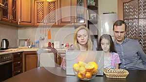 Family at home using computer webcamera, Internet communication