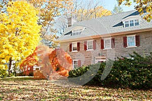 Family house with front lawn in fall colors