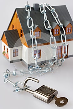 family house and metallic chain as a protection - key lock security system