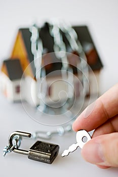 family house and metallic chain as a protection - key lock security system