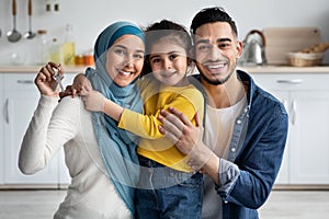 Family Housing Concept. Happy Islamic Spouses With Little Daughter Holding Home Keys