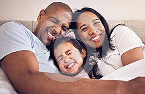 Family, hug and happy on a bed at home with a smile, comfort and security for quality time. Man, woman or latino parents