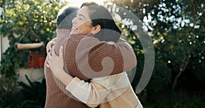 Family, hug and a senior father with his daughter in the garden of a home together for bonding during a visit. Love