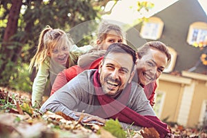 Family human pyramid. Autumn season.