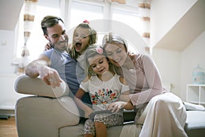 Family and iPod. Young family at home.