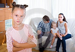 Family and jealous girl standing apart