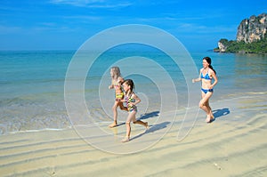 Family jogging on beach