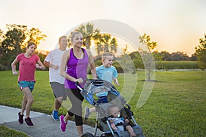 Family jogging and exercising outdoors together photo