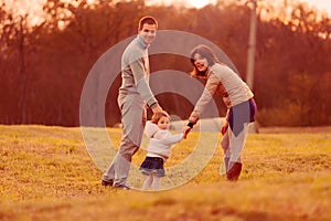 family joyfully ventures towards a forest