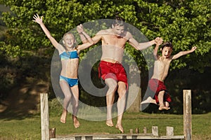 Family Jumping Into Lake