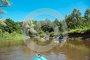 Family kayak trip. Man and woman and elderly couple senior and seniora rowing boat on the river, a water hike, a summer adventure