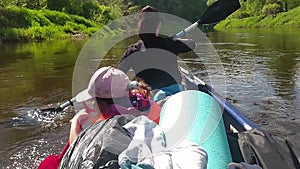 Family kayak trip. Mom and daughter rowing a boat on the river, a water hike, a summer adventure. Eco-friendly and extreme tourism