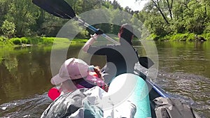 Family kayak trip. Mom and daughter rowing a boat on the river, a water hike, a summer adventure. Eco-friendly and extreme tourism