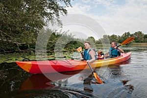 Family in a kayak on a water walk