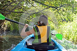 Family kayaking, child paddling in kayak on river canoe tour, kid on active autumn weekend and vacation, sport and fitness